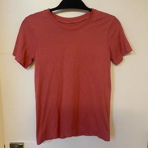Lululemon top in a orangeish, pinkish, red color. Size 4.